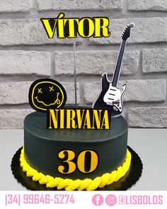 a black and yellow birthday cake with a guitar on top