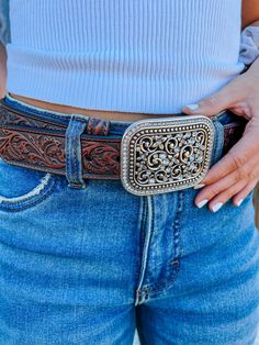 This stylish ladies Ariat belt has a beautiful tooled leather that matches the precise and fashionable engraving in the buckle. Add a little flare and pop to outfit with this fun belt from Ariat! Dark brown full-grain leather belt. 1 1/2 inch width. Filigree tooled design throughout with stitched trim. Large removable silver-tone square buckle with rhinestone accents and trim. Cute Belt Buckles Women, Adjustable Hand-tooled Belts, Ariat Belts, Country Belts, Tooled Belt, Cowgirl Belts, Belt With Buckle, Clog Slippers, Pink Sparkly