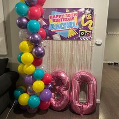 the balloon arch is decorated with balloons and streamers for an 80th birthday party