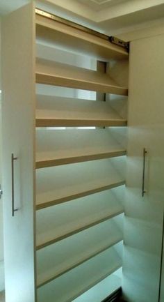 an empty closet with sliding doors and shelves