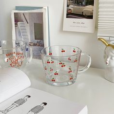 two glass cups sitting on top of a white desk