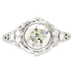 an antique style diamond ring with filigrees