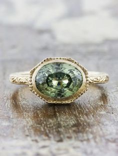 a green ring sitting on top of a wooden table