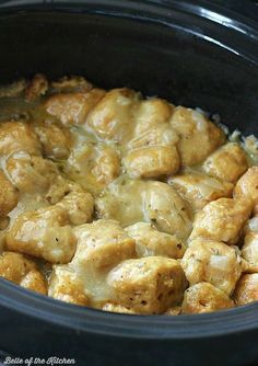 a crock pot filled with chicken and gravy