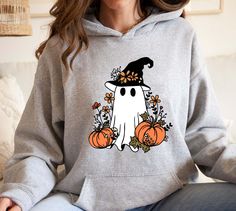 Floral Pumpkin Ghost Hoodie,Halloween Ghost Hoodie, Cute Halloween Hoodie, Halloween Women's Hoodie,Spooky Season Hoodie,Pumpkin Fall Hoodie   PRODUCT DETAILS 💫Youth Hoodies do not have drawcord for added safety💫 - Our hoodies are made for comfort with a 50% cotton and 50% polyester blend. - They're built to last with a medium-heavy fabric  (8.0 oz/yd² (271 g/m - Enjoy a relaxed fit and a sewn-in label. - Get the right size with our true-to-size guide.   SIZING - Find your perfect fit in our s Halloween Hooded Spooky Sweatshirt, Spooky Hooded Halloween Sweatshirt, Hooded Spooky Halloween Sweatshirt, Spooky Long Sleeve Halloween Hoodie, Halloween Hoodies, Ghost Hoodie, Floral Pumpkin, Hoodie Cute, Women's Hoodie