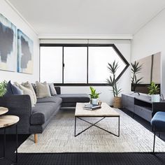 a living room filled with furniture and a large window