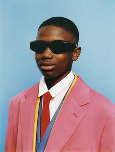 a man in a pink suit and sunglasses on the cover of s & s magazine