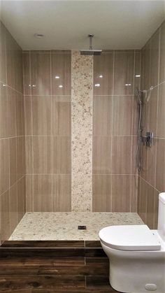 a bathroom with tiled walls and wooden flooring