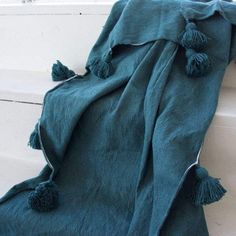 a blue blanket with tassels on it