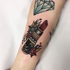 a woman's arm with a diamond and lipstick tattoo on the left side of her leg