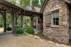 a stone house with an attached covered porch