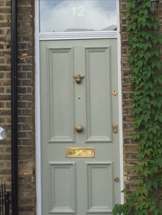 the front door to a house with ivy growing on it's side and number 12