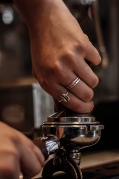 a person is pouring something into a coffee pot