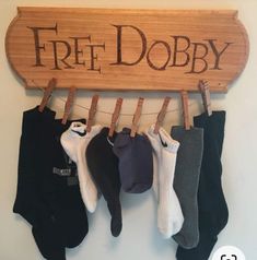 there is a sign that says free dobby hanging from the clothes line with five pairs of socks