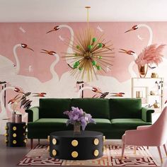 a living room decorated in pink and green with flamingos painted on the wall behind it