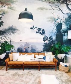 an instagram page with a couch, lamp and painting on the wall