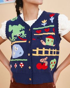 a woman wearing a blue sweater vest with pictures on it