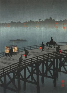 an image of people walking on a bridge over the water at night with boats in the distance