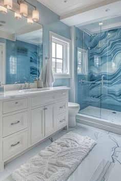 a bathroom with blue and white marble on the walls, flooring and shower stall