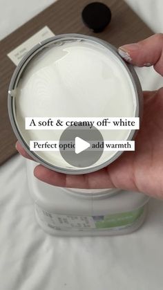 a person is holding a white container with some liquid in it that says, soft & creamy off - white perfect opiti add warm