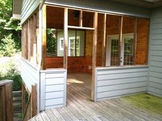 the back porch is covered with wood siding