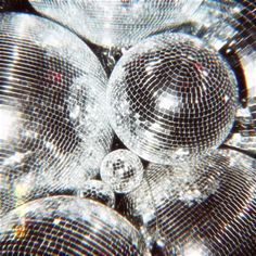 an image of some disco balls that are in the middle of each other's face