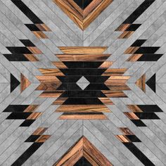 an abstract pattern made up of wood and concrete blocks with black, brown, gray and white stripes