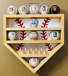 a wooden shelf with baseballs and bats on it in the shape of a triangle