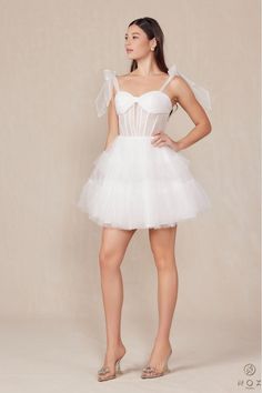 How dreamy is this White Tulle A-Line Mini?! Tulle Tie straps meet a ruched bandeau style bust and corset style bodice and flow into a layered tulle skirt. This dress will have you twirling on the dance floor all night long! Finished with an invisible zipper. Final Sale. Looking for a different size? Message us to inquire about availability to special order in sizes 00-16, don't forget to include the date of your event! Fitted Bodice Tulle Tutu Dress For Prom, Tulle Tutu Dress With Fitted Bodice For Prom, Summer Tulle Corset Dress For Bridesmaids, Summer Bridesmaid Tulle Corset Dress, Strapless Sweetheart Neckline Organza Dress, Prom Corset With Tulle Skirt And Fitted Bodice, Fitted Strapless Organza Dress With Sweetheart Neckline, Bridesmaid Tutu Dress With Fitted Bodice And Tulle Skirt, White Dress With Ruched Bodice Overbust