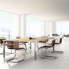 an empty conference room with chairs and a table in the foreground, overlooking a cityscape