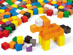 an animal made out of colored blocks sitting on the ground