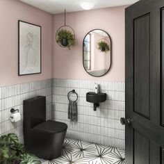 a bathroom with pink walls and white tile on the floor, black fixtures and mirrors