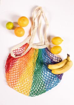 a bag full of fruit sitting on top of a white table