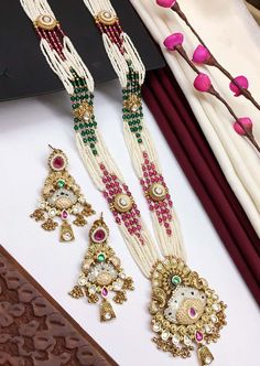 This Rajwadi Bandhai necklace is not just a piece of jewelry; it carries with it a rich heritage and cultural significance. With its timeless allure this necklace features layers of pearl piroyi with gold embellishments, beautiful meenakari, studded with Kundan tukdis, semi precious stones, cluster & gold beads. Matching earrings included. Statement Jewelry. Perfect for any occasion. Festive Wedding Jewelry.  WHAT GOES IN  👉🏻Brass is used as base metal. 👉🏻Necklace length: 26- 28" & Drawstring Adjustable. ✅Check other styles available in our store https://www.etsy.com/shop/KKsCulture 💕Send us an email if you need help! We will be very happy to assist with any questions you may have. KKsCulture [at]gmail.com or WhatsApp: +1 (732) 325 2222 Luxury Temple Jewelry For Navratri, Luxury Meenakari Temple Necklace For Festive Occasions, Luxury Temple Necklace With Polished Beads For Festivals, Luxury Temple Necklace For Festive Occasion, Luxury Multicolor Temple Necklace For Festive Occasions, Luxury Temple Necklace With Stone Work For Celebration, Luxury Temple Necklace With Intricate Design For Navratri, Luxury Temple Jewelry Necklaces For Navratri, Luxury Temple Necklace For Navratri Gift