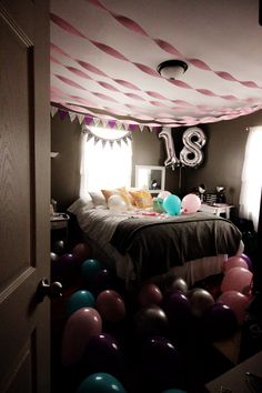 a bedroom decorated with balloons and streamers