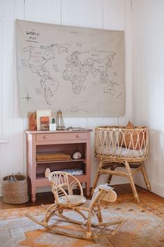 a baby's room with a map on the wall and rocking chair in front