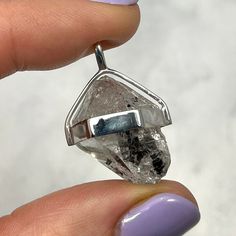 This unique Herkimer Diamond Healing Crystal Pendant is set in a 925 sterling silver girdle. Herkimer Diamonds are a double terminated form of quartz named after it's type locality, Herkimer County, New York, U.S.A.  Mineral Species - Quartz  Crystal System - Trigonal  Birthstone - Sagittarius  Chakra Alignment - Crown  Crystal Attributes:  Stimulates psychic gifts.  Brings in pure light and is used to clear the Chakras.  Considered to be an 'attunement' stone.  A powerful aid in attuning to ano Nickel Free Silver Diamond-shaped Jewelry, Modern Silver Jewelry With Vs Clarity, Nickel-free Diamond-shaped Jewelry Gift, Nickel-free Diamond-shaped Jewelry For Gifts, Silver Sterling Diamond-shaped Jewelry, Unique White Gold Jewelry With Si Clarity, Spiritual Clear Gemstone Jewelry, Silver Faceted Round Pendant Jewelry, Gift Herkimer Diamond Necklace In Silver