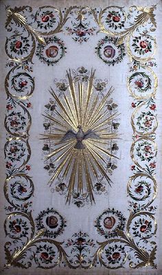 an ornate gold and white wall hanging