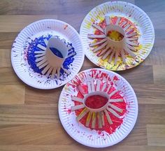 three paper plates that have different colored paint on them