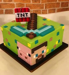 a cake made to look like a minecraft block with the word tht on it