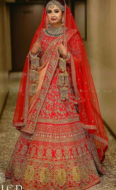 a woman in a red and gold bridal gown