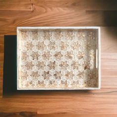 a wooden tray sitting on top of a hard wood floor