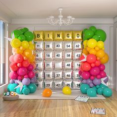 a room filled with balloons and numbers on the wall, next to a giant calendar