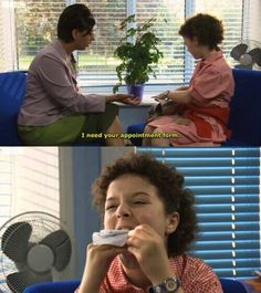 two women sitting in chairs and one is holding a remote control