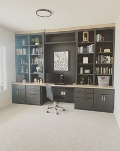 an office with built in bookshelves and desk