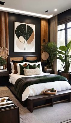 a bedroom with black walls, white bedding and green plants on the side of the bed