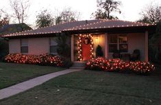 a house decorated with christmas lights and wreaths