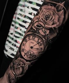 a man's arm with a clock and roses on it