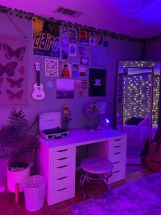 a bedroom with purple lighting and lots of pictures on the wall above the dressers