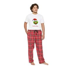 "Step into comfort with our exclusive \"Men's Comfy Cotton Pajama Set.\" Embrace the ultimate relaxation with our 100% cotton ensemble, perfect for those leisurely days and cozy nights. Our pajamas boast a fashionable plaid pattern on straight leg pants, complete with convenient side pockets, paired with a solid color top, creating a timeless style that's 200% comfy. The unisex retail fit top ensures a comfortable and flattering look for everyone. Make these pajamas uniquely yours by adding a touch of whimsy with our Grinch-themed design, and personalize it further with your name. Whether it's a treat for yourself or a thoughtful gift, these pajamas promise to be an instant favorite in anyone's wardrobe. Our commitment to quality is evident in the tear-away labels, ensuring nothing but com Green Flannel Pajama, Christmas Pyjamas For Men, Grinch Mens Pajama Pants, Green Pajama Shorts With Elastic Waistband, Relaxed Fit, Mens Pajamas Set, Family Christmas Pajamas, Cotton Pajama Sets, Kids Set, Plaid Pants